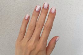 Short natural nails in blush pink with glossy finish and minimalist white line design