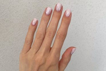 Short natural nails in blush pink with glossy finish and minimalist white line design