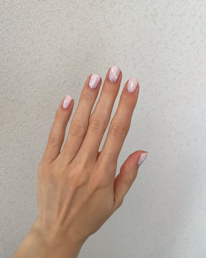Short natural nails in blush pink with glossy finish and minimalist white line design