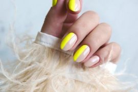 half neon yellow and half nude nails in a glossy oval-round shape