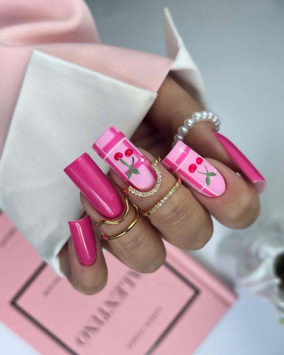 Long square nails in hot pink with cherry art and striped accents on pink base
