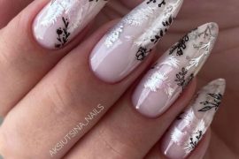 Almond nude nails with black and silver leaf nail art over a glossy pink base
