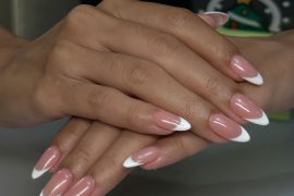 Long almond-shaped nails with nude pink base and clean white French tips