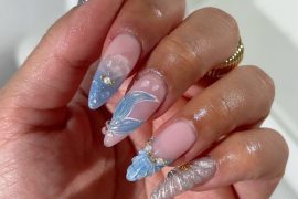 Long stiletto nails with chrome silver, blue jelly tips, and seashell textures on a pink-nude base