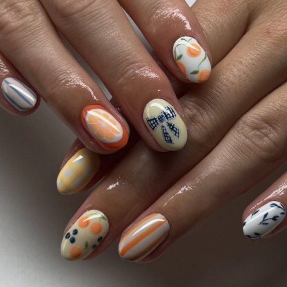 Short oval nails with citrus slices, gingham bows, floral prints, and colorful mix-and-match fruit patterns