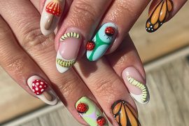 Almond-shaped nails with butterfly wings, ladybug charms, red mushrooms, and forest-inspired insect nail art