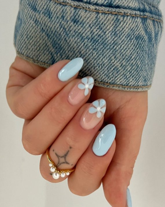 pastel blue almond nails and white flower nail art on sheer nude base