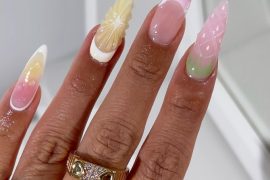 Long stiletto nails with pink, yellow, and green pastel gradients and 3D fruit-inspired textures