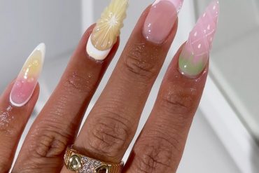 Long stiletto nails with pink, yellow, and green pastel gradients and 3D fruit-inspired textures