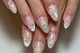 Romantic bridal nails with pastel florals, pearls, and gold accents—perfect for weddings, engagements, or any soft glam occasion.