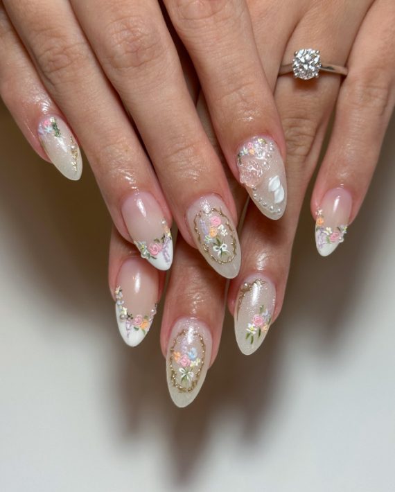 Romantic bridal nails with pastel florals, pearls, and gold accents—perfect for weddings, engagements, or any soft glam occasion.