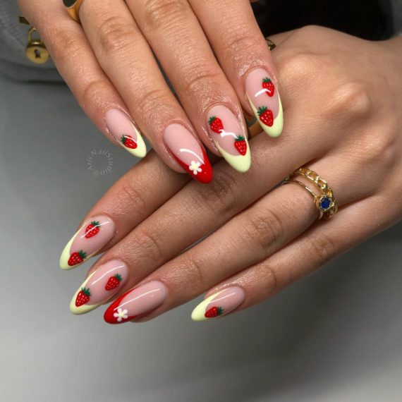 Almond-shaped nails with hand-painted strawberries, pastel French tips, and daisy details on a nude base