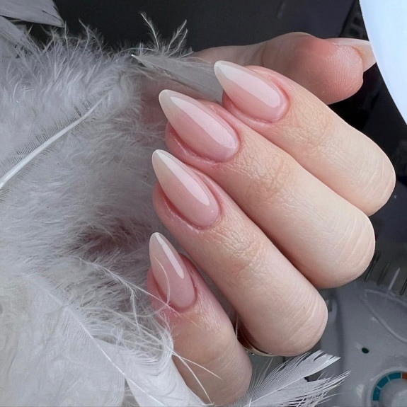 Sheer nude almond nails with translucent gradient for a soft summer look