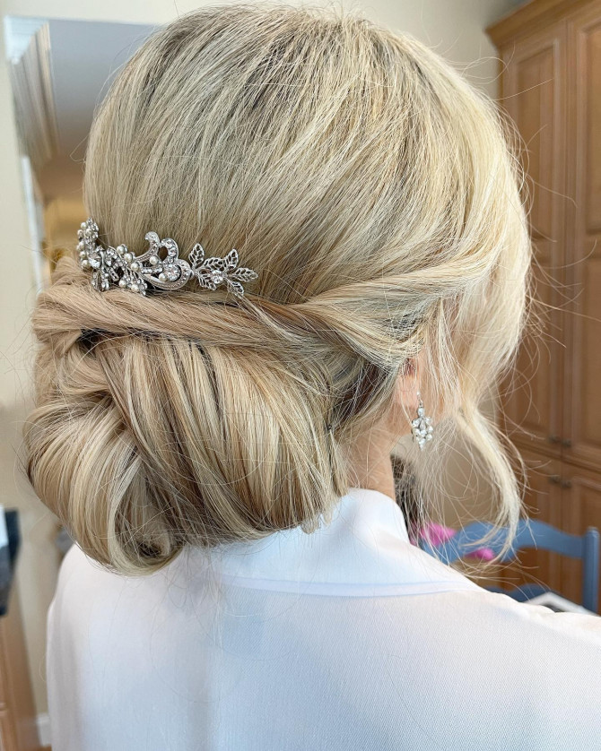 Twisted low bun in platinum blonde with crystal comb.