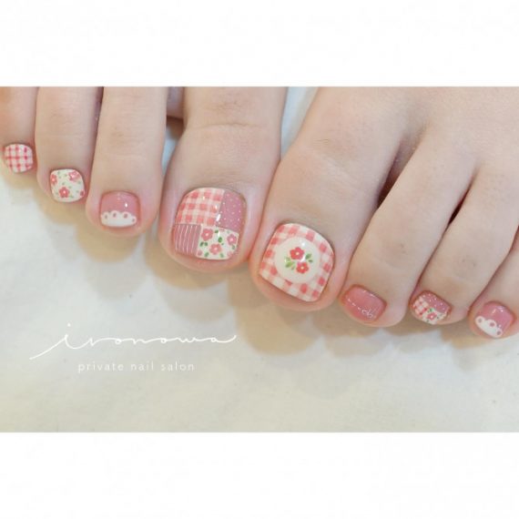 Pink gingham toenail art with mini florals, polka dots, clouds, and patchwork quilt design
