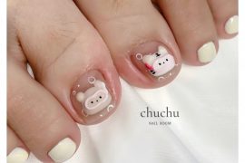 Toe nails with nude base and 3D piggy and bunny designs, paired with off-white polish on surrounding toes