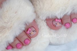 Cute Hello Kitty pedicure with pink polish on all toes and hand-painted character faces with pink bows on big toes.