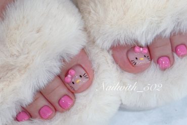 Cute Hello Kitty pedicure with pink polish on all toes and hand-painted character faces with pink bows on big toes.
