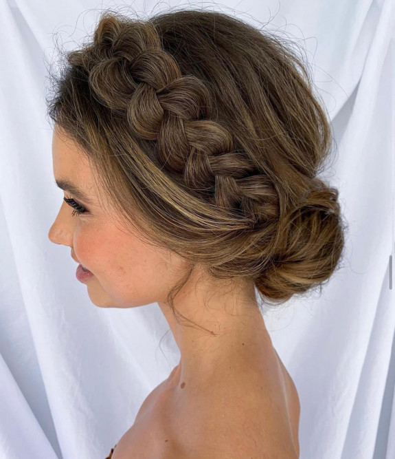 Dutch crown braid bridal bun with natural brunette tones.