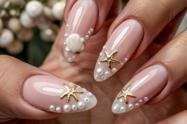 Nude almond nails with gold starfish and pearl shell accents for summer