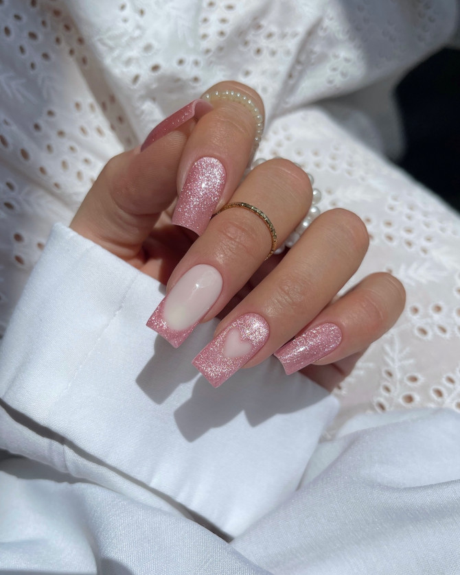 Nude square nails with pink glitter and a soft heart design for summer. Nude square nails with pink glitter and a soft heart design for summer