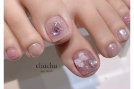 Soft pink toe nails with shimmer finish, crystal cherry and 3D bow embellishments in neat square shape