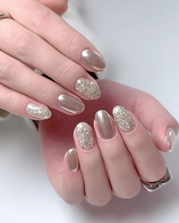 gold chrome nails with chunky glitter accents in oval shapeelegant and playful nail designs with nude tones and gold foil