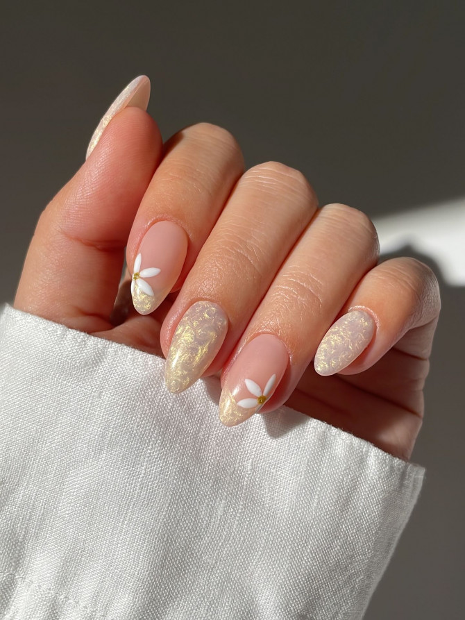 Golden daisy French tips with embossed shimmer on almond nails