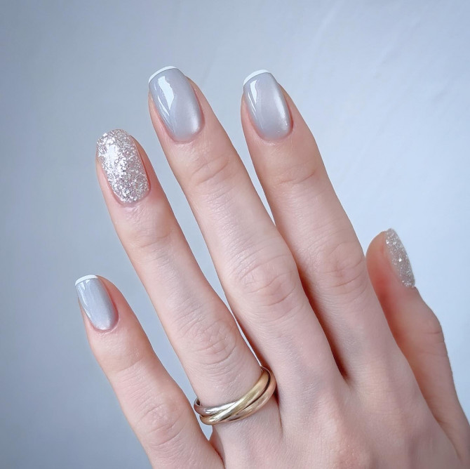 short square icy silver nails with glitter accent on ring and pinky finger