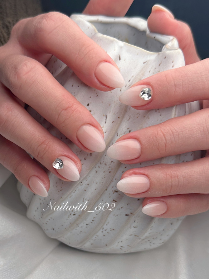 Minimal bridal nails with soft milky ombré and a single gemstone—elegant and understated design for modern brides. 