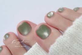 Minimalist olive green toenail design with semi-matte finish and smooth texture