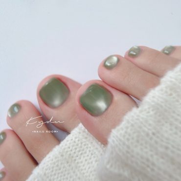 Minimalist olive green toenail design with semi-matte finish and smooth texture