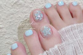 Pastel blue pedicure with floral glitter nail art on big toes