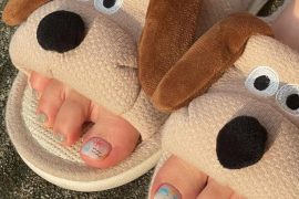 Toe nails with pastel rainbow gradient base and hand-drawn doodles on short square shape for a fun summer look