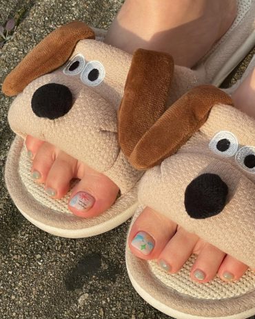 Toe nails with pastel rainbow gradient base and hand-drawn doodles on short square shape for a fun summer look