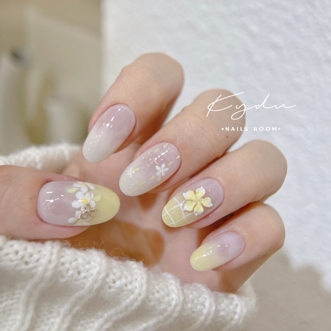 Pastel yellow and sheer pink bridal nails with 3D floral accents, ombré gradients, and fine grid detailing—perfect for spring weddings. 