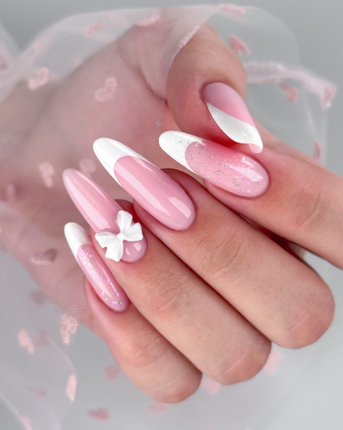 Pink French bridal nails with white tips, glitter accents, and a 3D bow—fun and elegant manicure for romantic brides. 