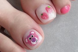 Toe nails with pink polish, Lotso bear art on big toe, and glossy strawberry design on short square nails