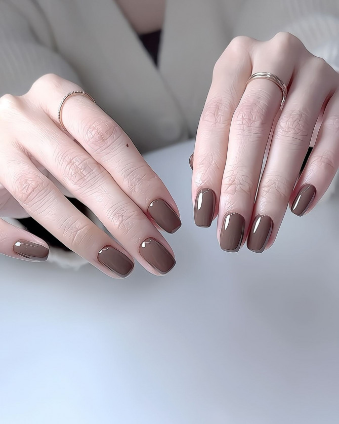 Short rounded-square nails in glossy cocoa brown