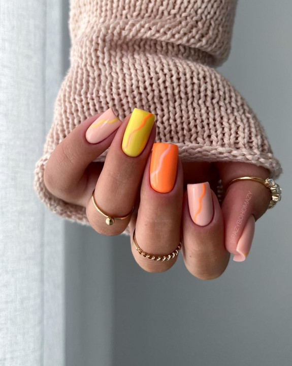 Nude square nails with peach, orange, and yellow wave accents for summer