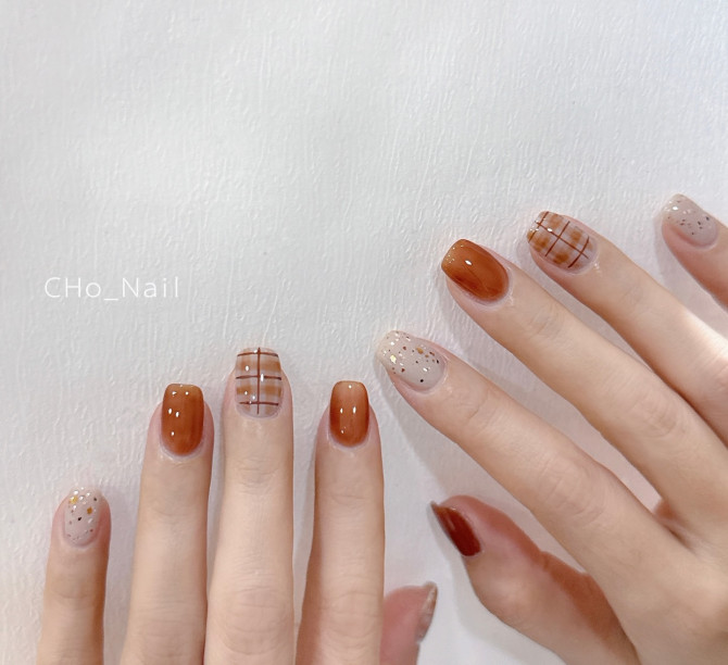 Latte plaid nails with gold speckles and warm caramel polish