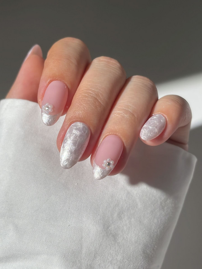 White floral French tip almond nails with pearl flower accents