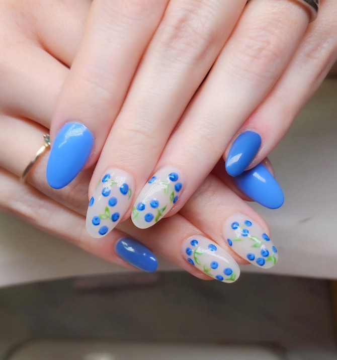  blueberry nail designs with solid blue polish and hand-painted berries on clear base