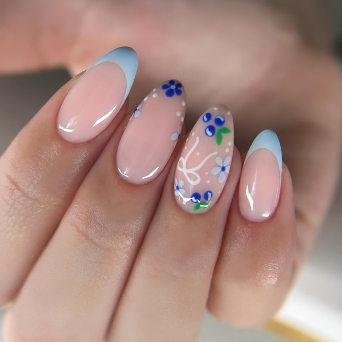 blueberry nail designs with floral accents, nude base, and pastel blue French tips