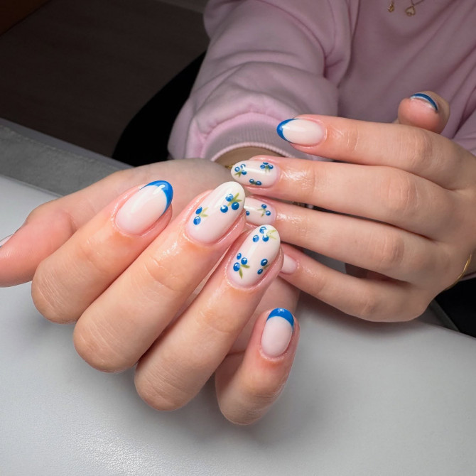 blueberry nail designs with bold French tips and scattered berry patterns on nude base