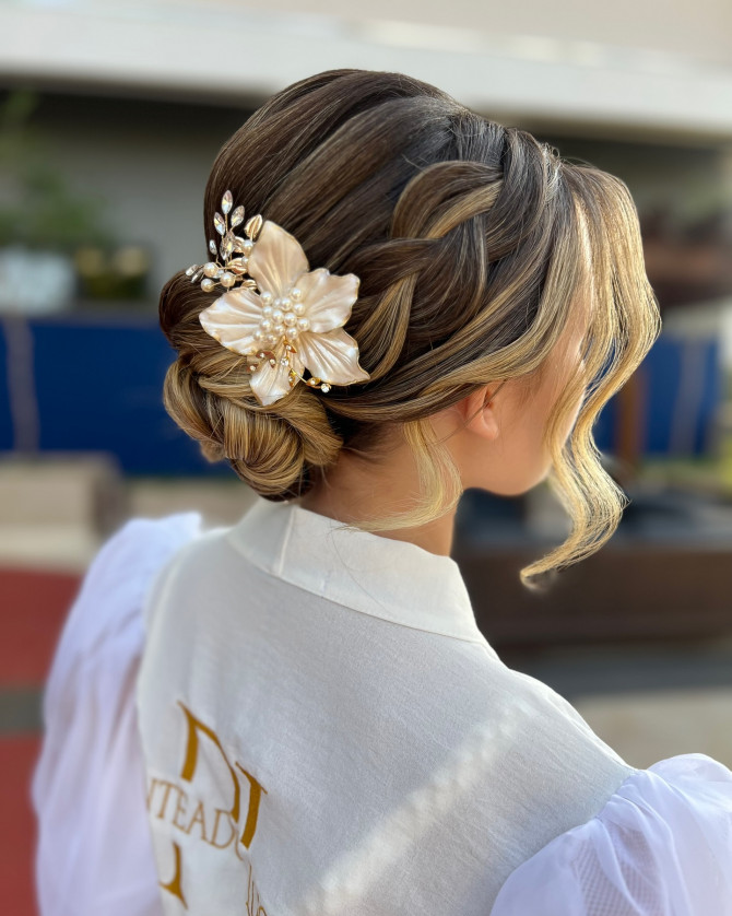 Romantic braided low bun with pearl floral hairpiece and soft curls by @penteadoslucena