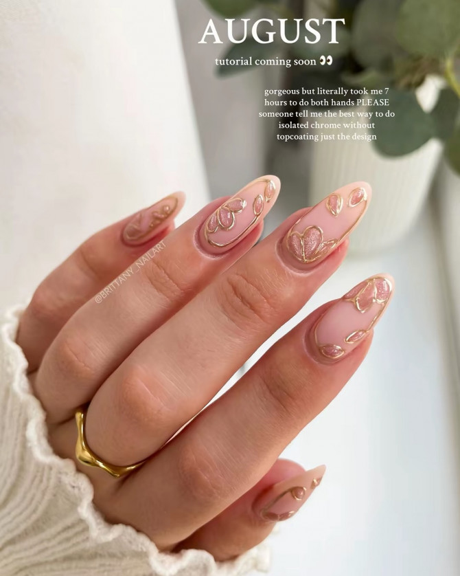 Nude chrome floral nails with gold outlines