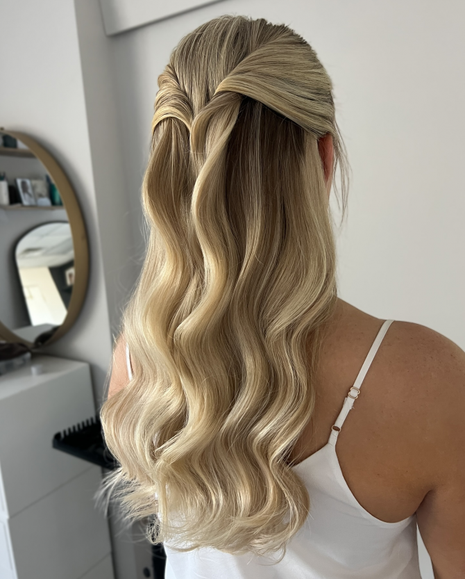 Blonde bridal half-up hairstyle with criss-cross twist and soft Hollywood waves by @erikataftbridal. Boho romantic bridal hairstyle with bubble braid