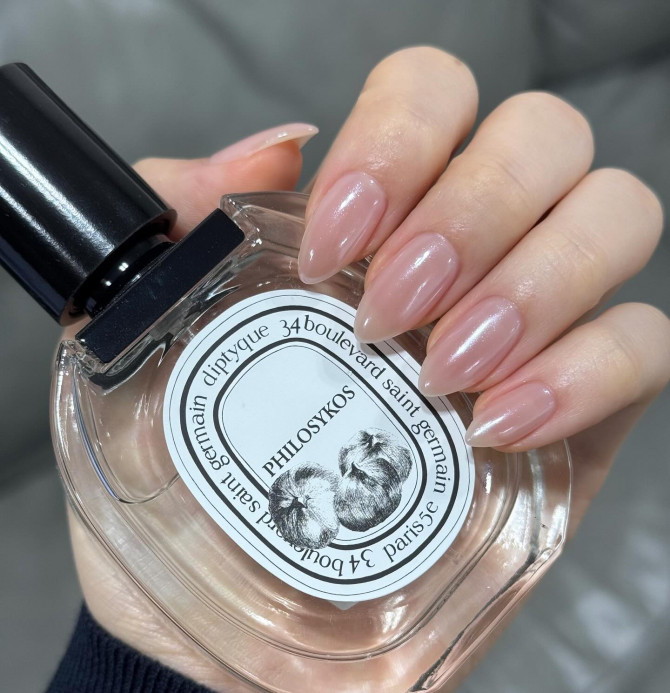  Elegant bridal nail designs featuring glossy almond nude nails with subtle chrome sheen.