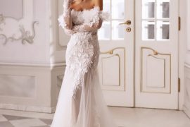 : Bride in feather off-shoulder wedding gown with lace bodice and long tulle train